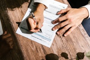 Person Writing on White Paper